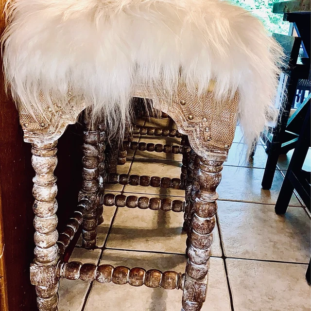 Long hair Icelandic sheepskin chair pads shown on bar stools at the counter.