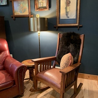 brown lambskin draped over the back of a rocking chair in the living room.