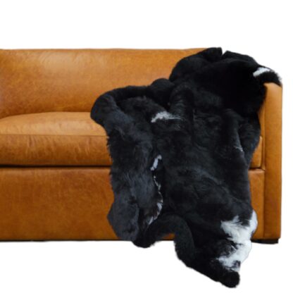 Real fur genuine sheepskin throw blanket black on sofa