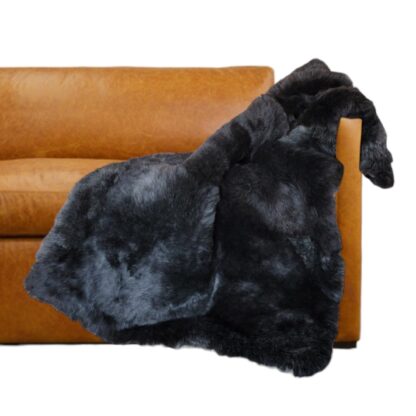 Wolf Gray Tip Natural sheepskin throw blanket on a sofa