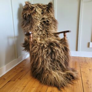 Real long hair brown Icelandic sheepskin double shown in rocking chair