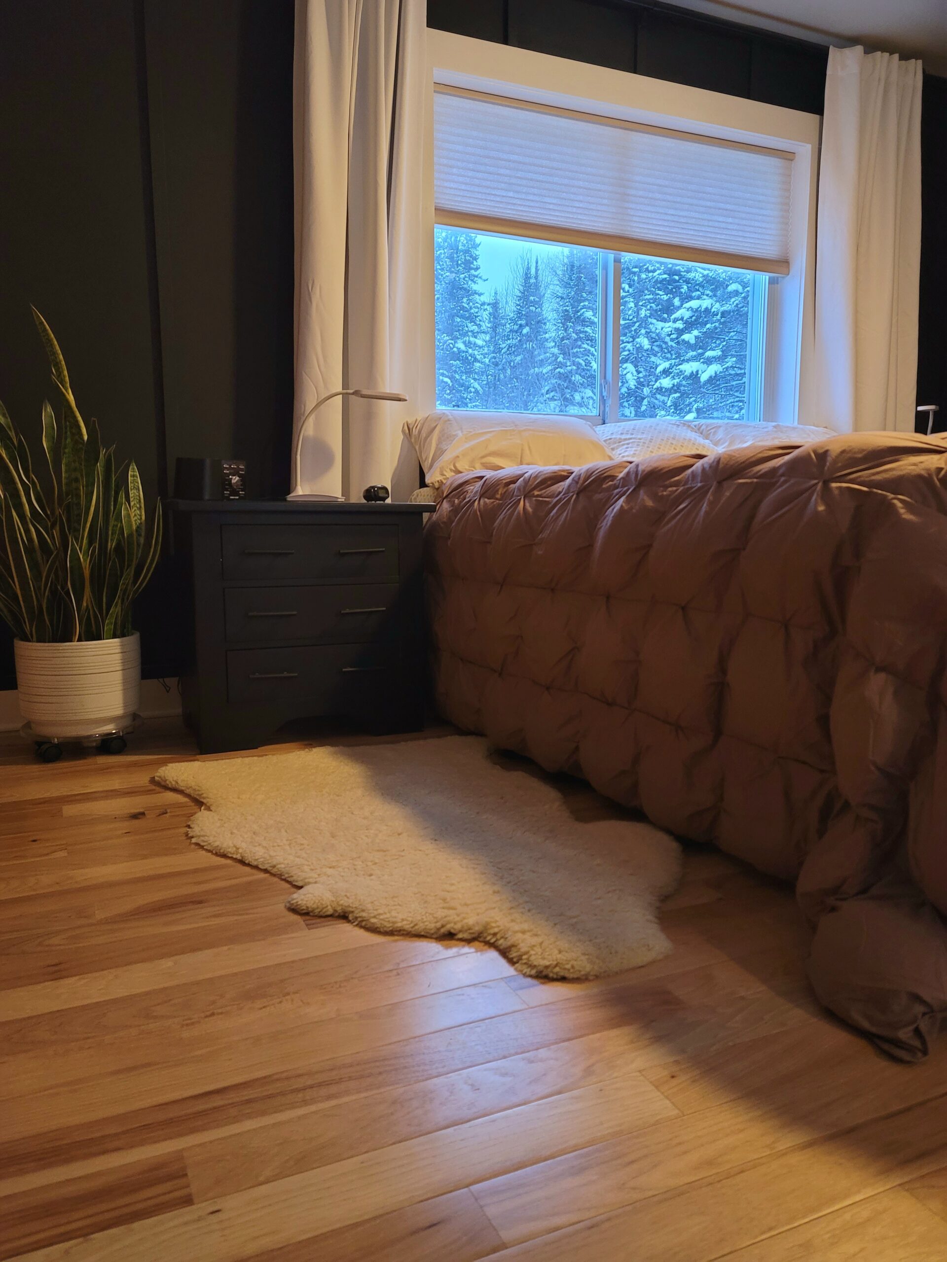 Medical Grade Sheepskin Rug shown on floor by a bed