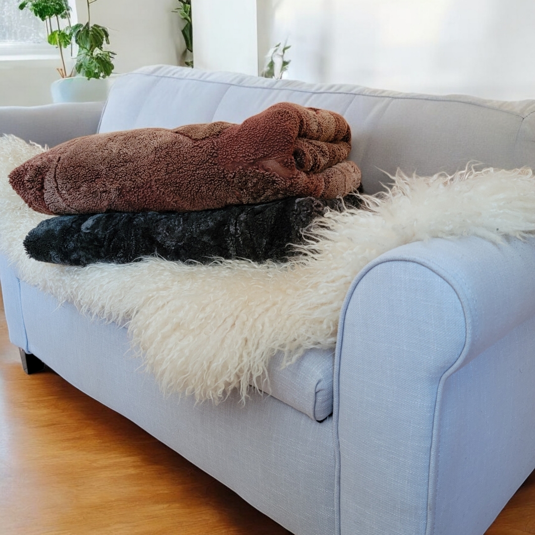 sheepskin blanket and sheepskin pelt on a sofa to create a cozy warm room