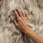 soft sheepskin closeup photo with hand in fur