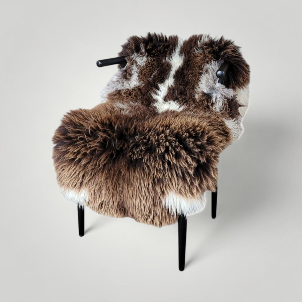 Giant thick spotted sheepskin hide shown in chair