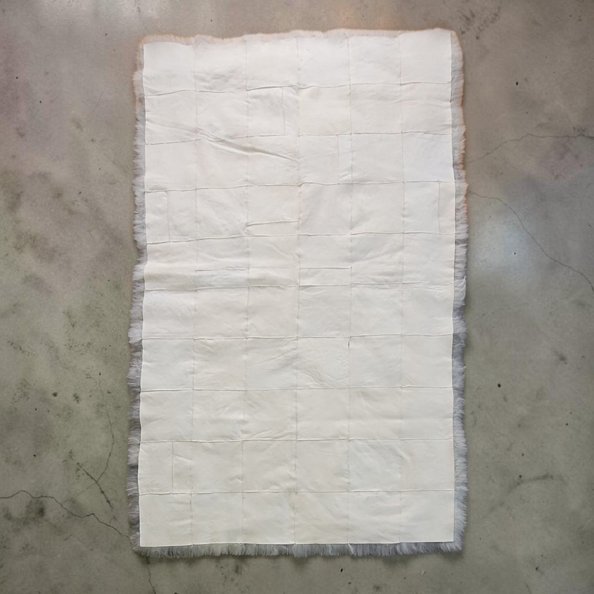 Designer Lambskin Blankets Backside of a rectangle sewn sheepskin area rug