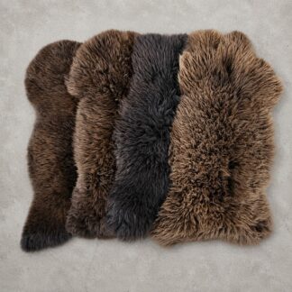 Large brown sheepskin rugs displayed on the floor to demonstrate colors within this rug collection