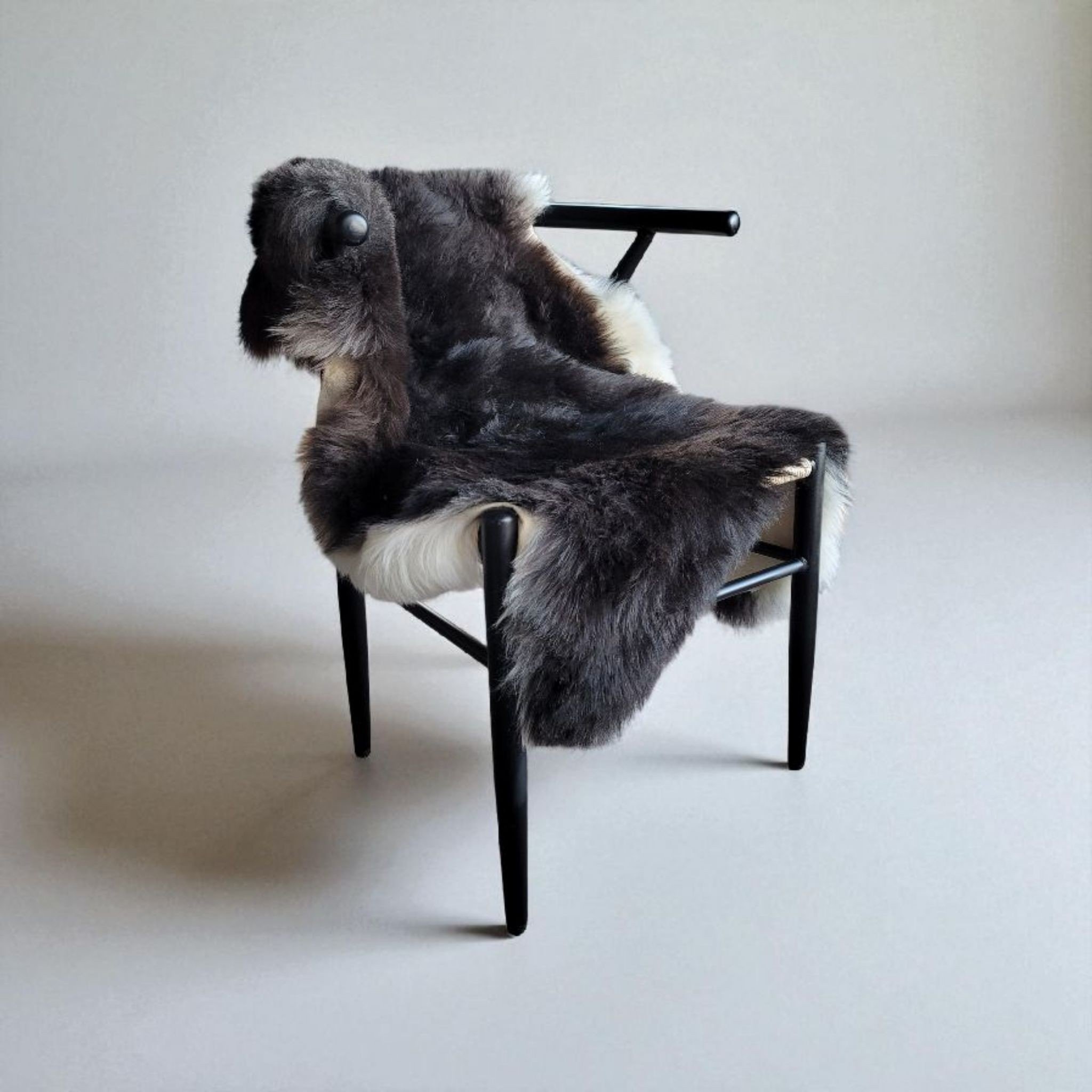Blacky brown natural Icelandic lambskin displayed in chair