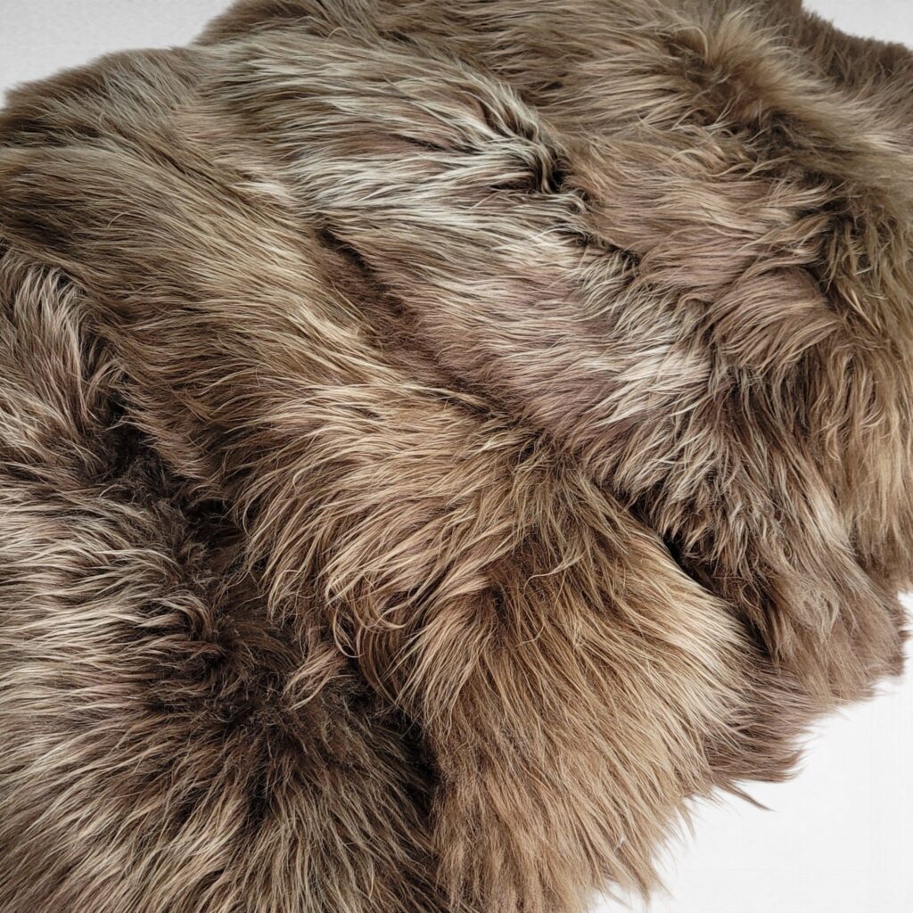 Golden Brown eco-dye sheepskin rugs shown layered on the floor