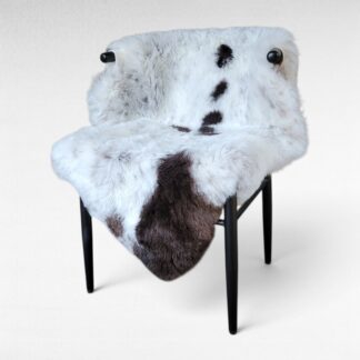 Flecks & spots sheepskin throw displayed on a chair
