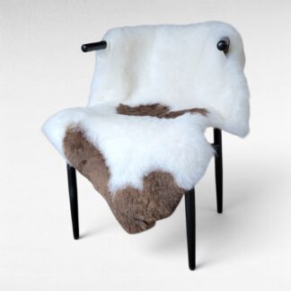 Light brown and white Icelandic sheepskin rug displayed on a chair