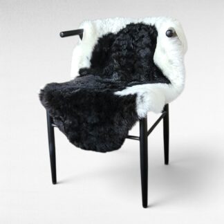 sleek black and white sheepskin displayed on a chair