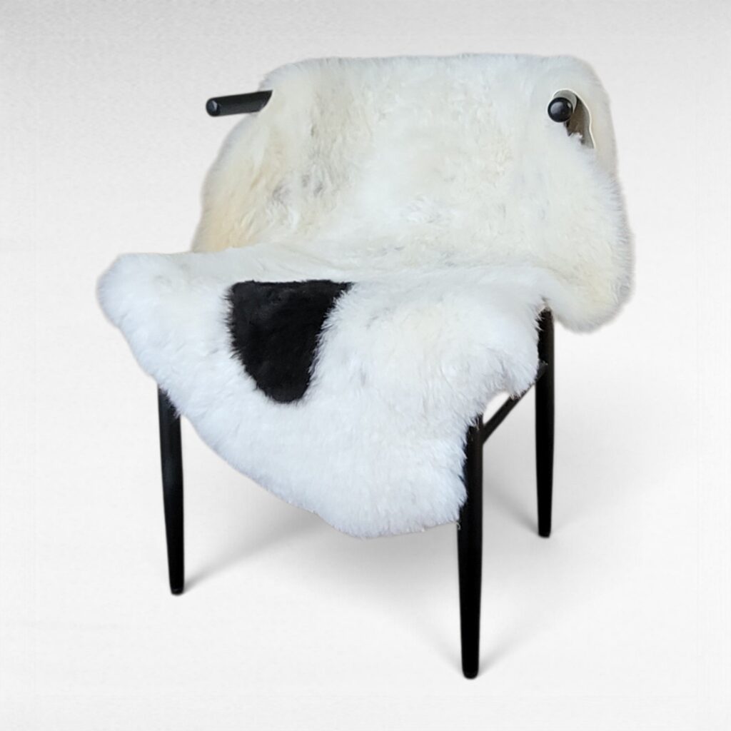Single spot Icelandic sheepskin rug with flecks throughout displayed on a chair