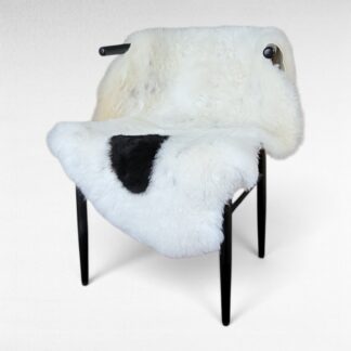 Single spot Icelandic sheepskin rug with flecks throughout displayed on a chair