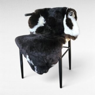 Silky shiny soft dark brown wool Icelandic lambskin displayed on a chair