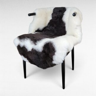 Soft brown spotted Icelandic sheepskin displayed in a chair
